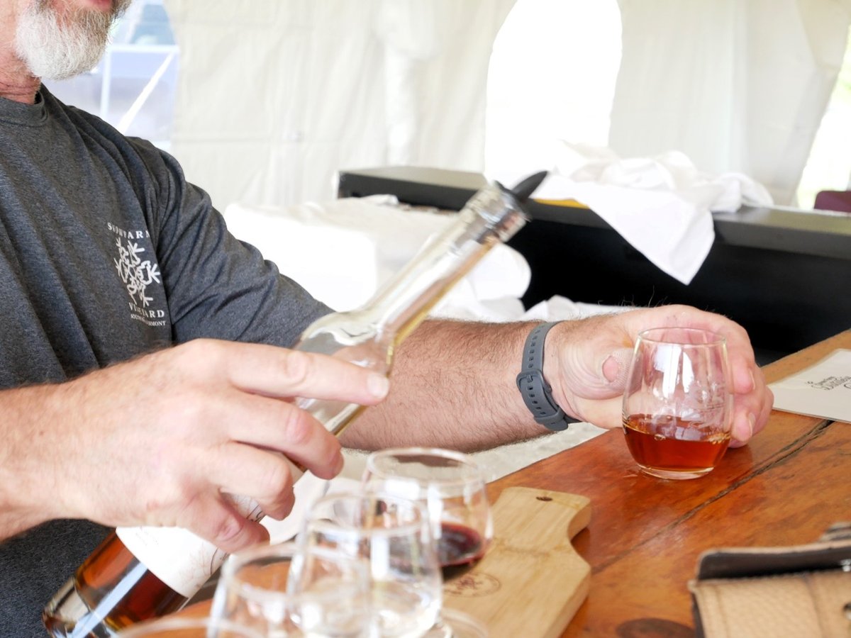 Vermont distillery pouring maple liqueur